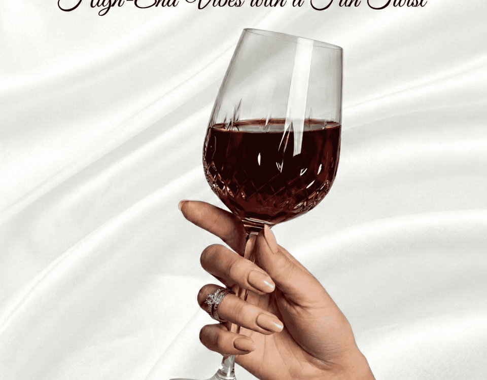 Hand with luxury nails holding a wine glass on a silk background.